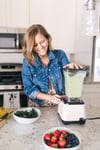 michelle cehn making a smoothie in her kitchen.